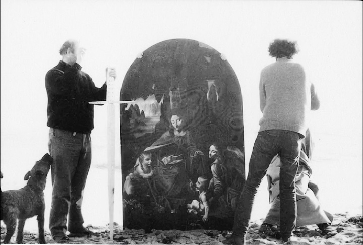 Lionel Miskin painting on an open book